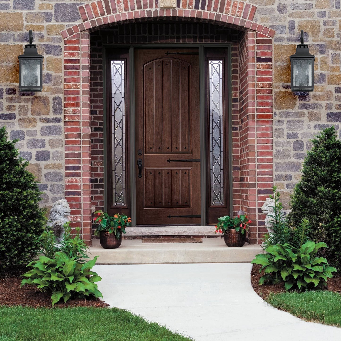 Dark wood entry door with arched top and decorative glass sidelights