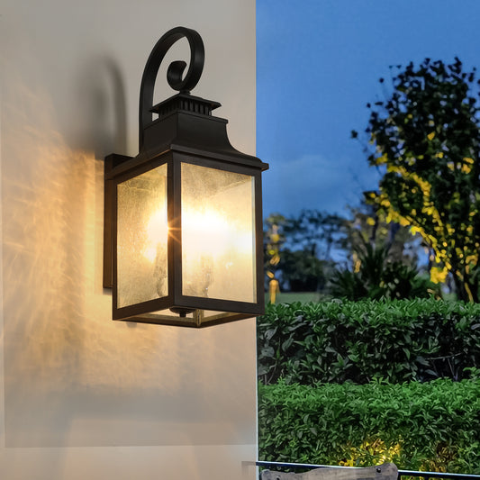Black traditional outdoor wall lantern with frosted glass panels and elegant scroll arm detail