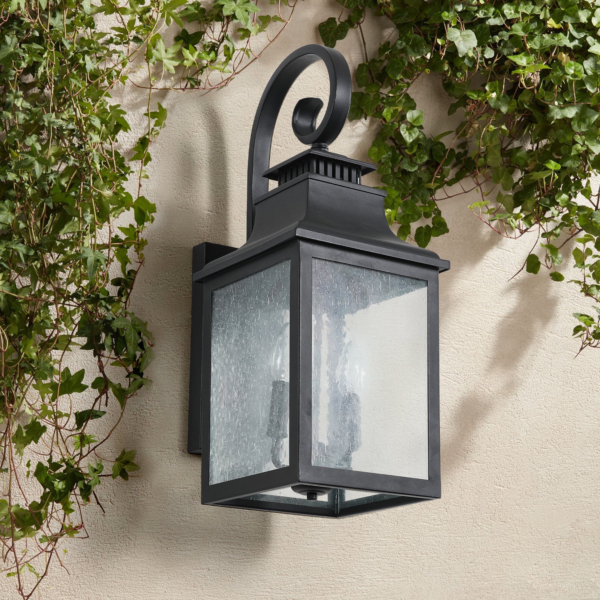 Black traditional outdoor wall lantern with seeded glass panels