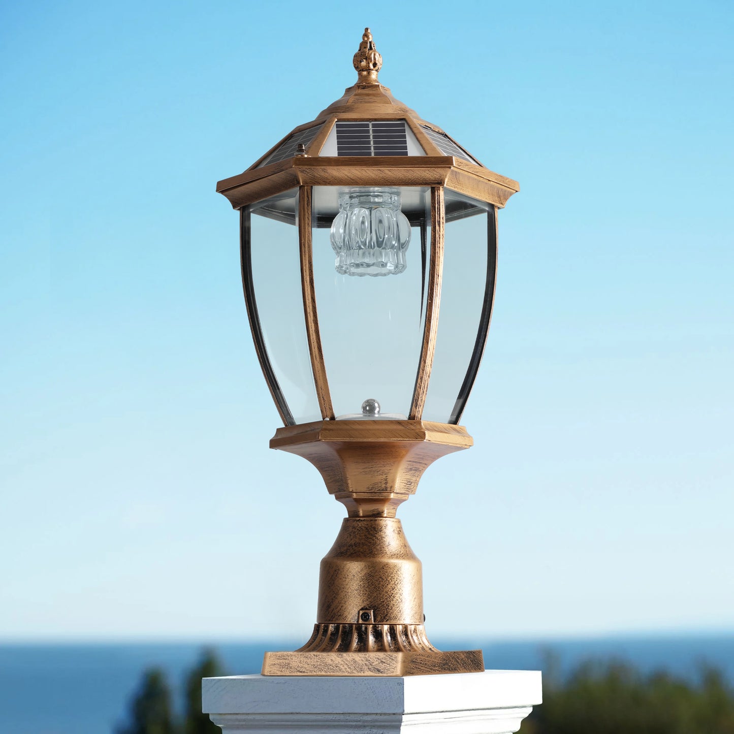 Antique brass solar post lamp with clear glass lantern and octagonal top