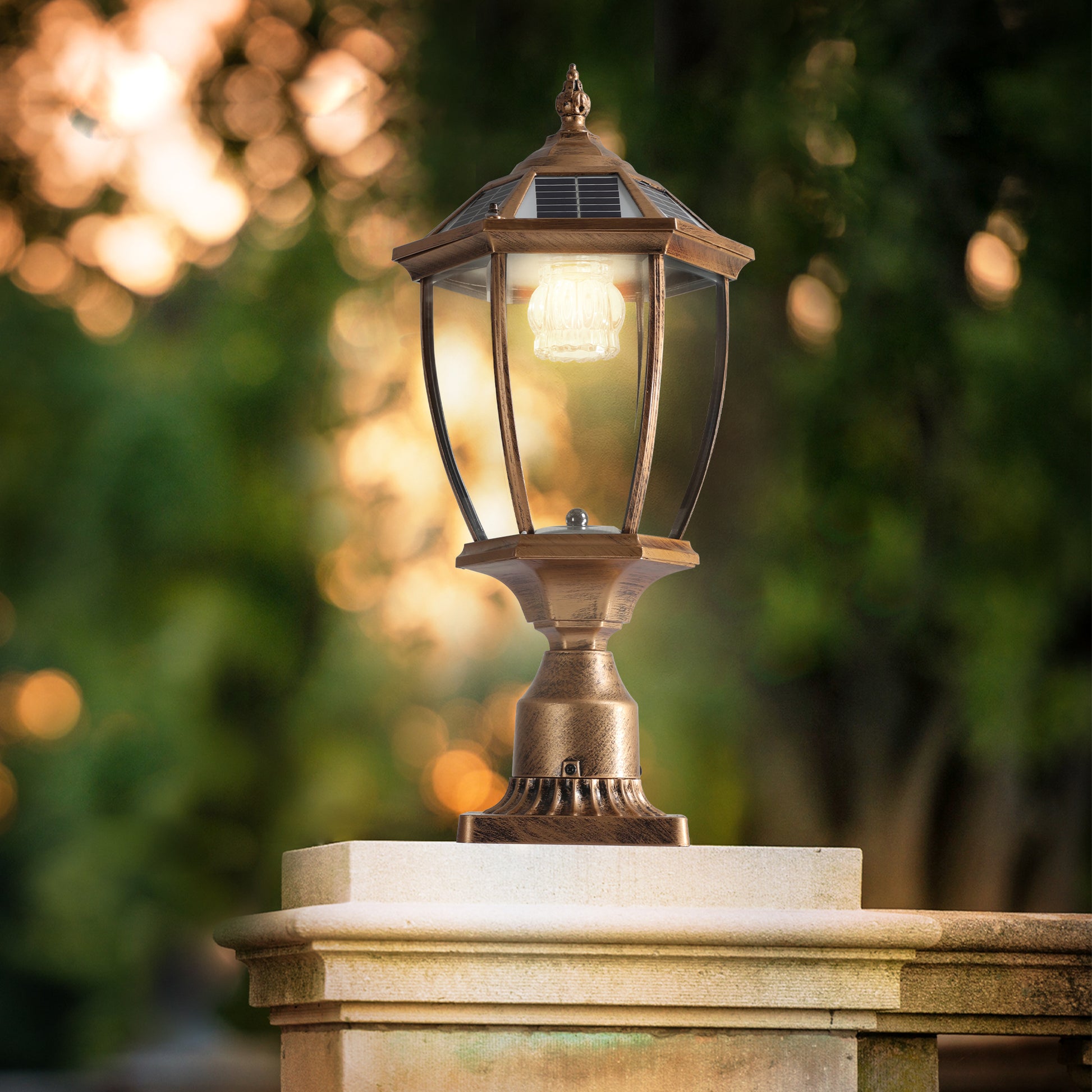 Antique bronze solar post cap light with hexagonal glass lantern and warm LED illumination