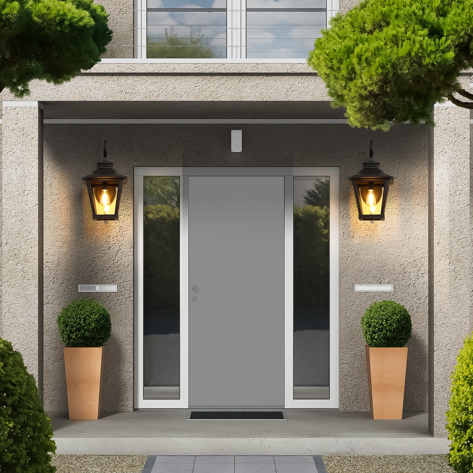 Traditional black metal outdoor lantern with clear glass panels providing warm inviting light