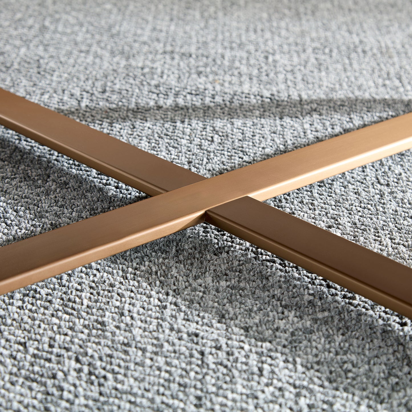 Bronze metal Xframe base for modern furniture on grey carpet
