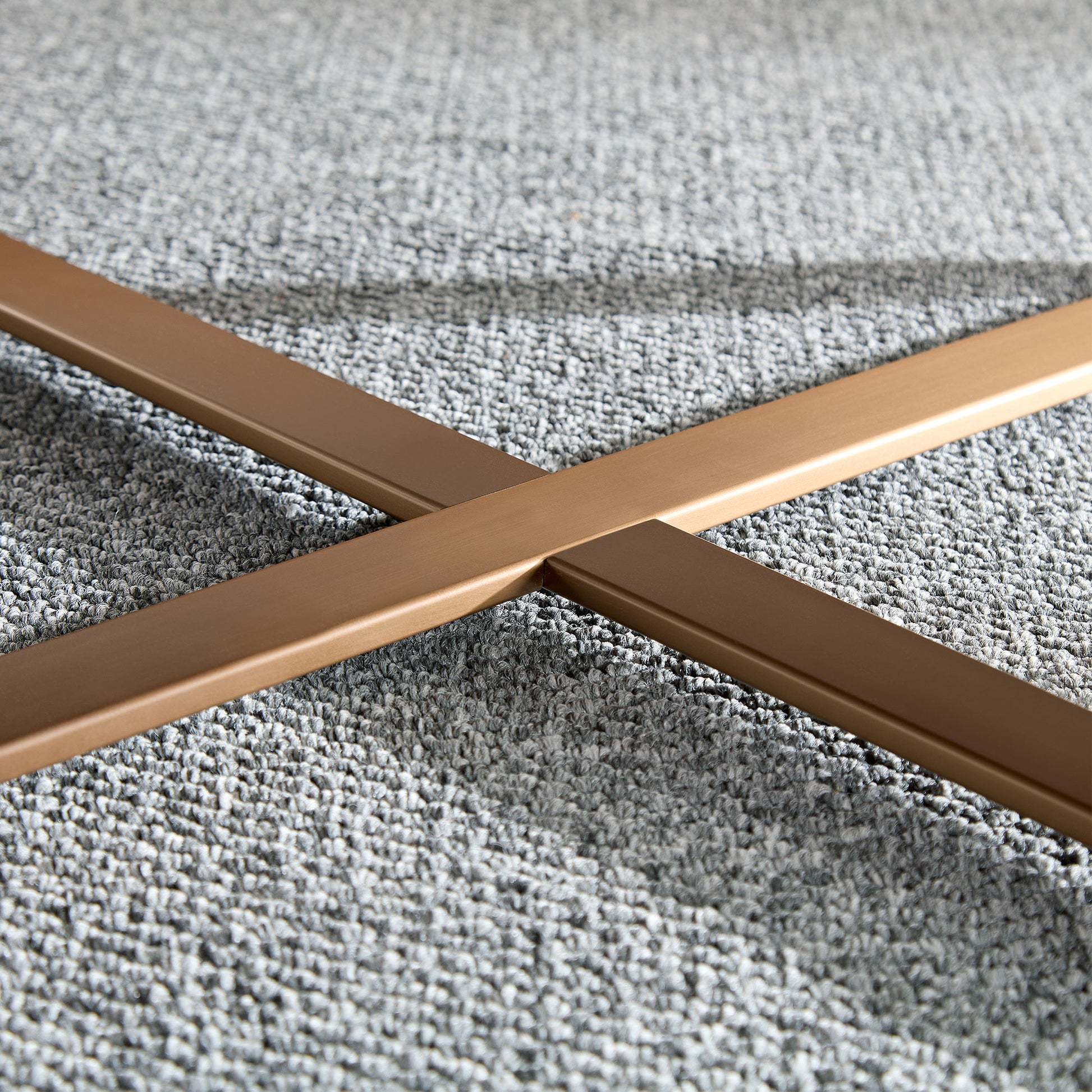Bronze metal Xframe base for modern furniture on grey carpet
