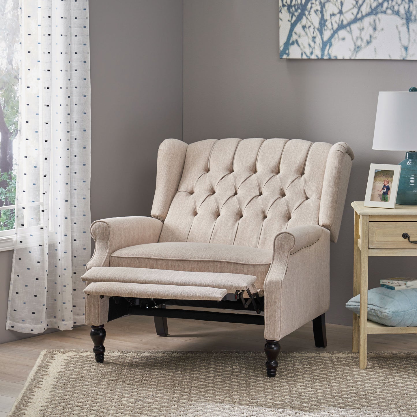 Tufted beige recliner with extended footrest classic wingback design and nailhead trim