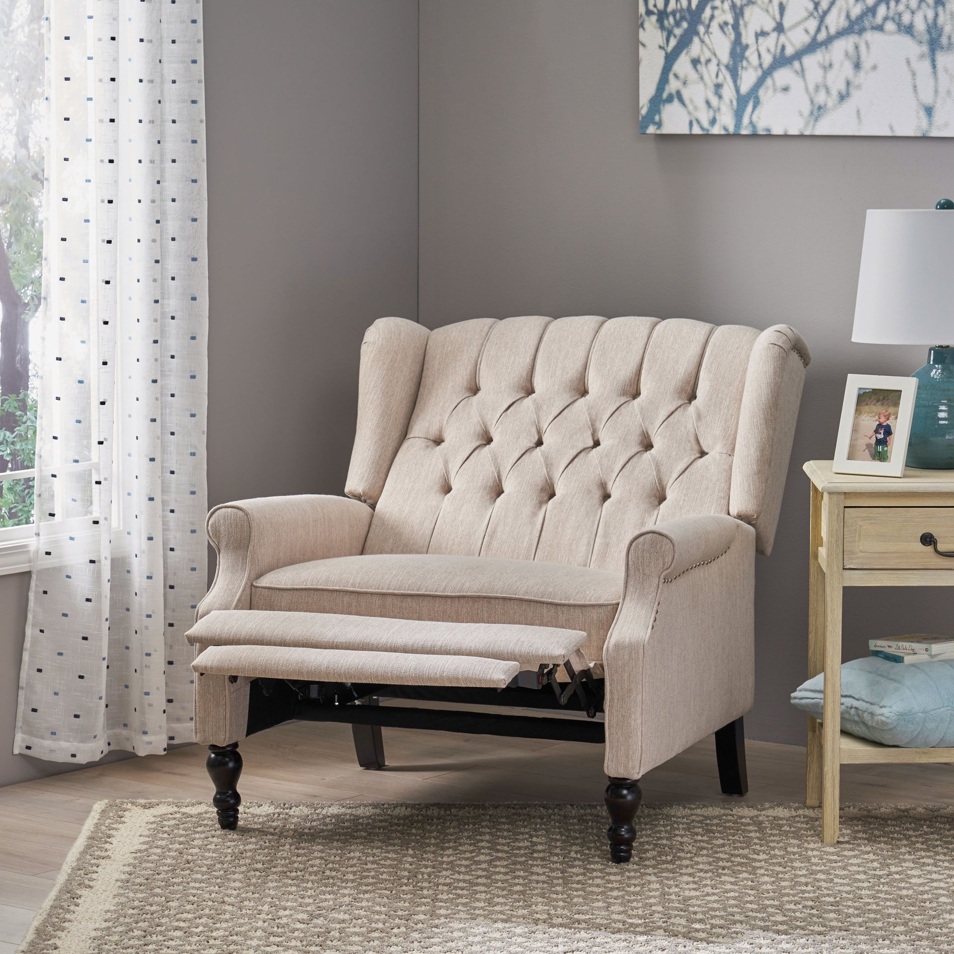 Tufted beige recliner with extended footrest classic wingback design and nailhead trim