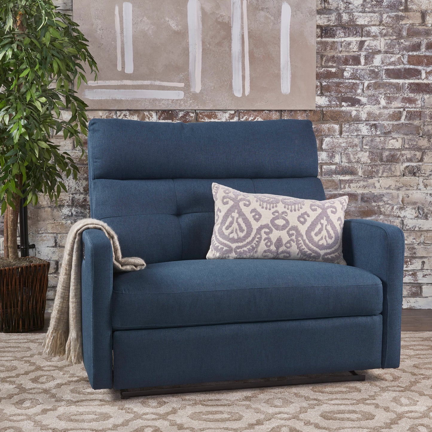Navy blue upholstered recliner chair with tufted back and accent pillow