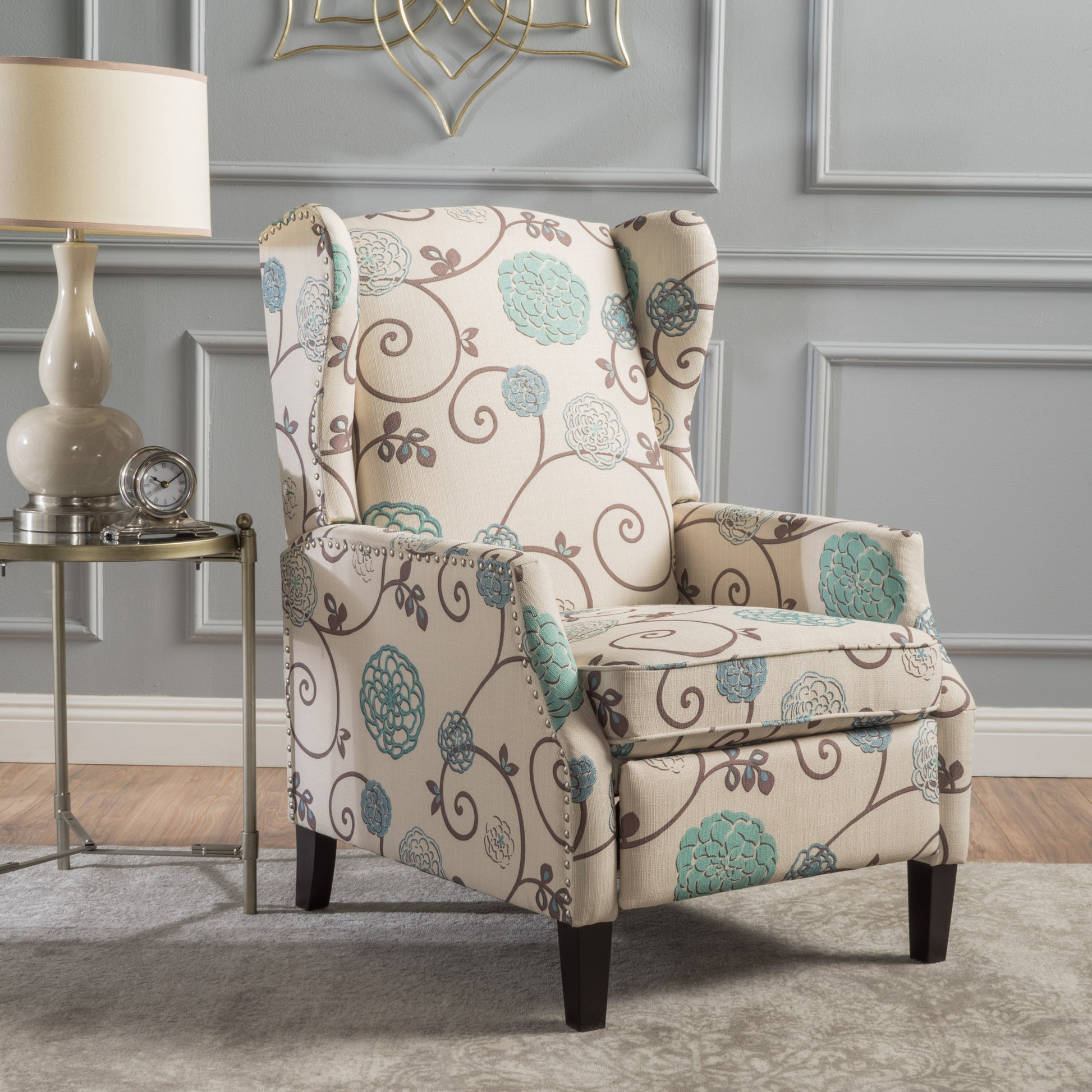 Cream and blue floral upholstered wingback chair with nailhead trim