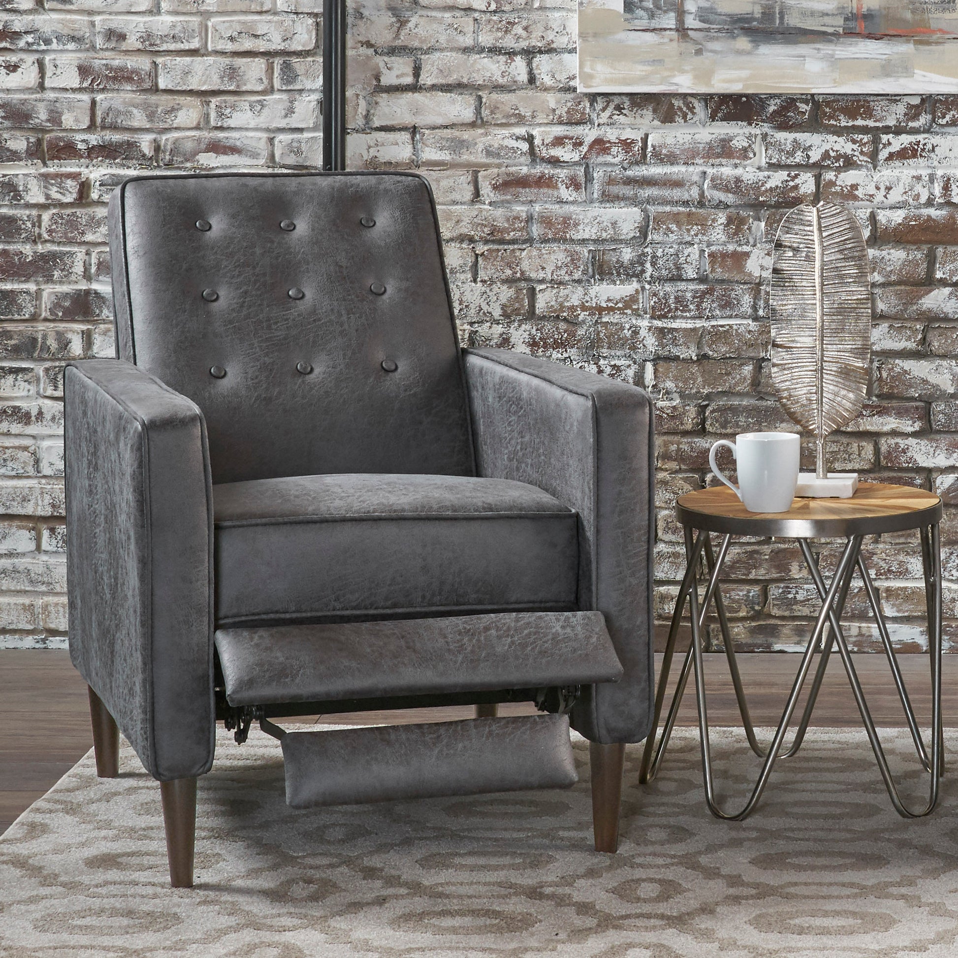 Dark gray tufted faux leather recliner with extended footrest