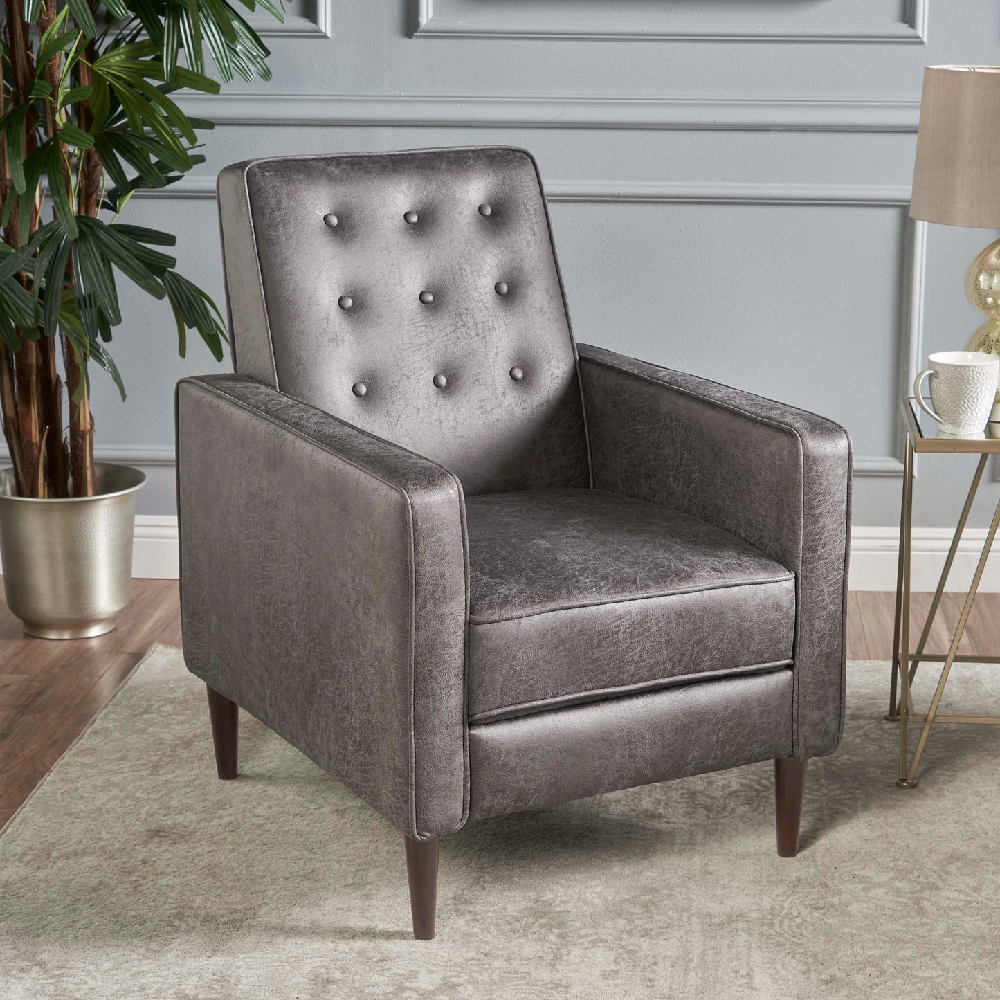 Tufted grey faux leather armchair with midcentury modern design and wooden legs