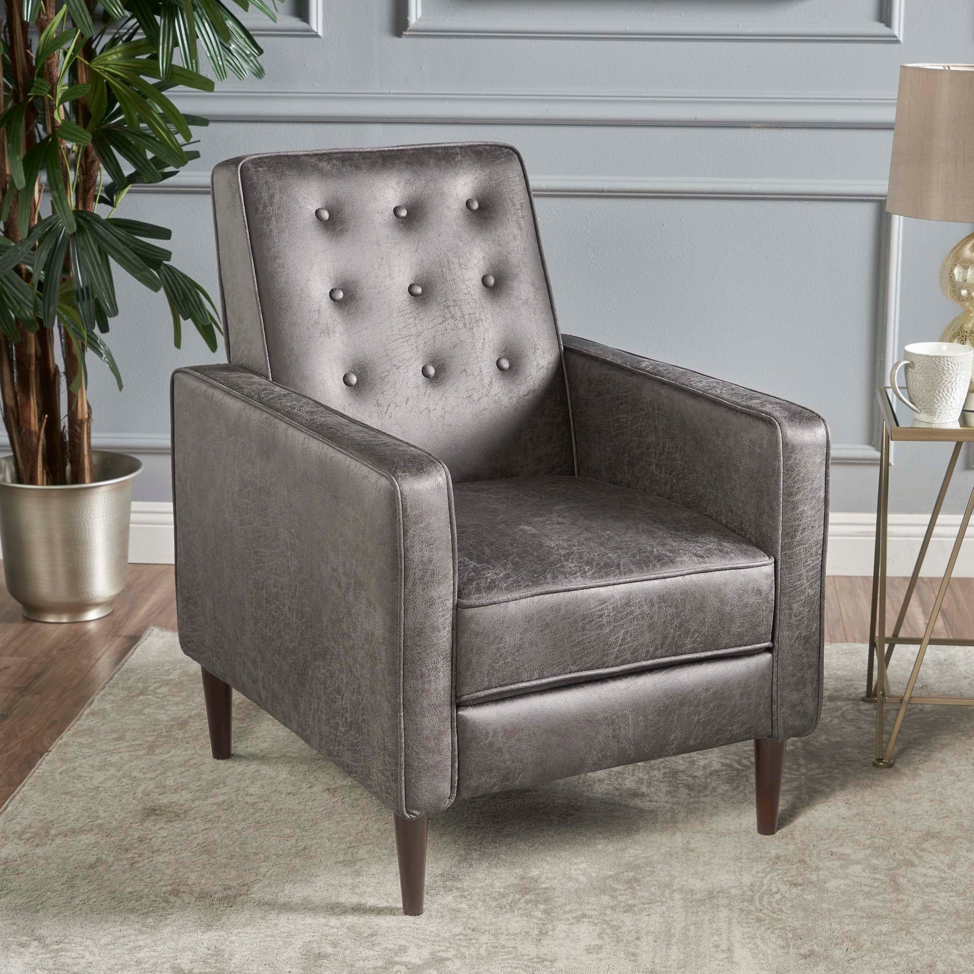 Tufted grey faux leather armchair with midcentury modern design and wooden legs