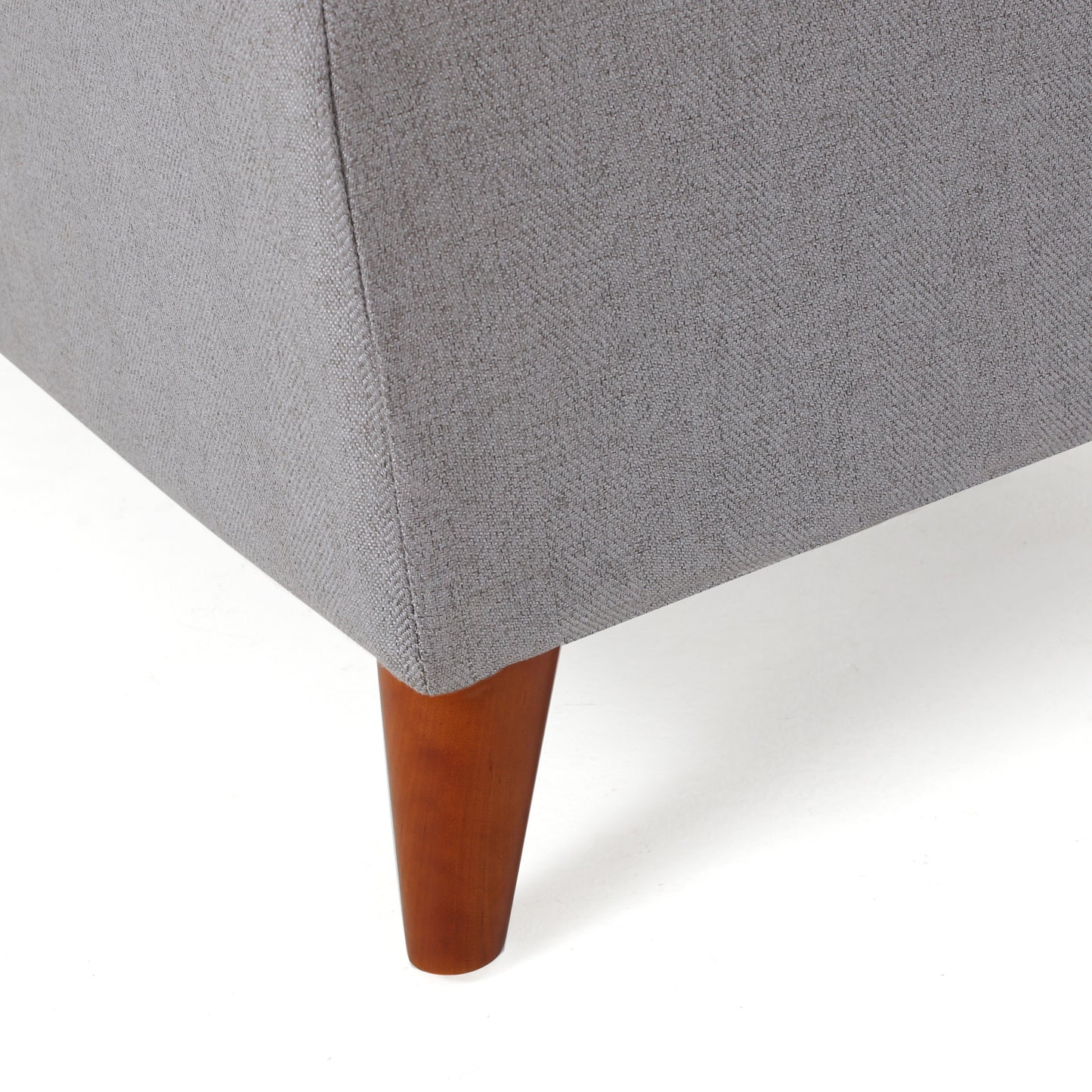 Gray textured fabric sofa corner with tapered wooden legs