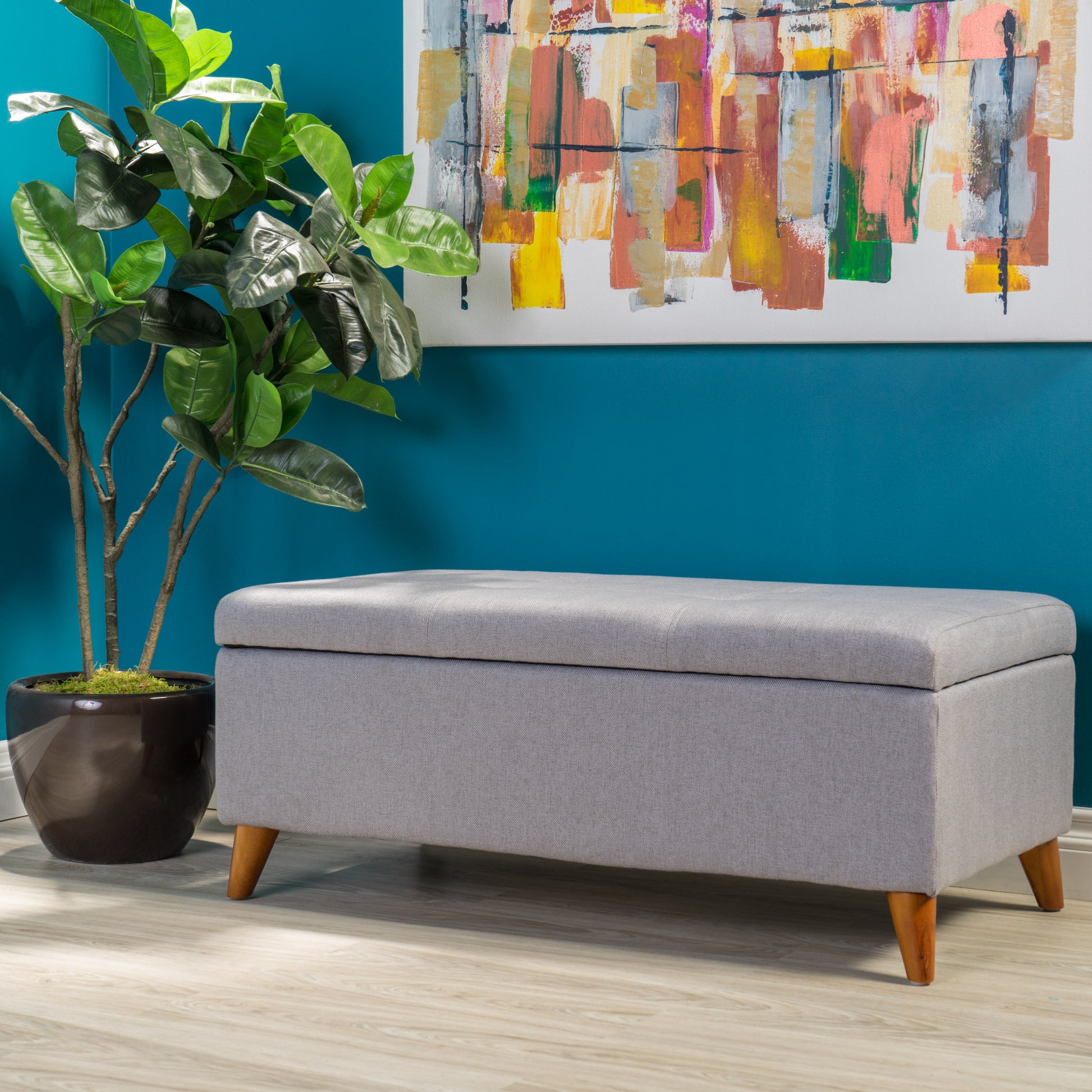 Gray fabric storage ottoman with wooden legs ideal for entryway organization