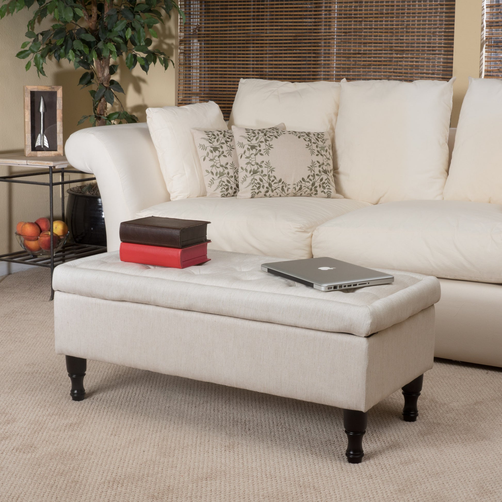 Tufted linen storage ottoman in beige with dark wood legs perfect for living rooms