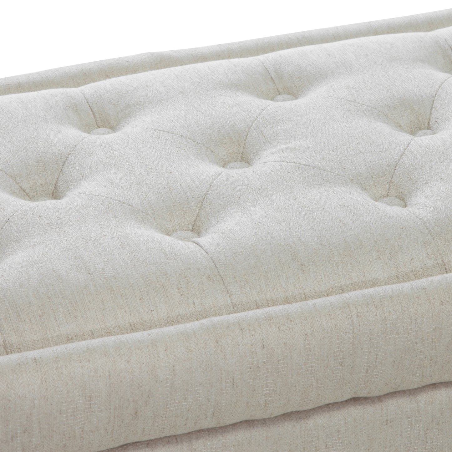 Closeup of tufted beige linen ottoman with subtle herringbone texture for elegant home decor