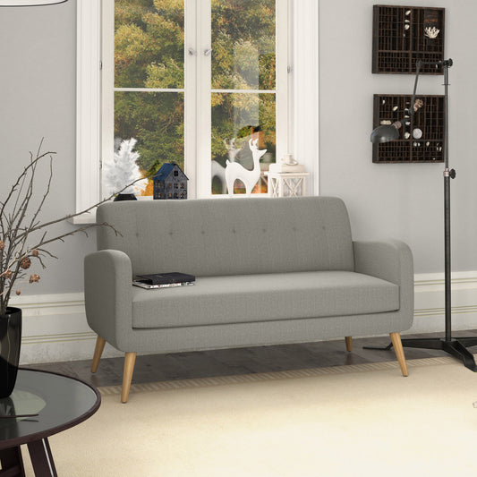 Gray upholstered loveseat with wooden legs and button tufting detail