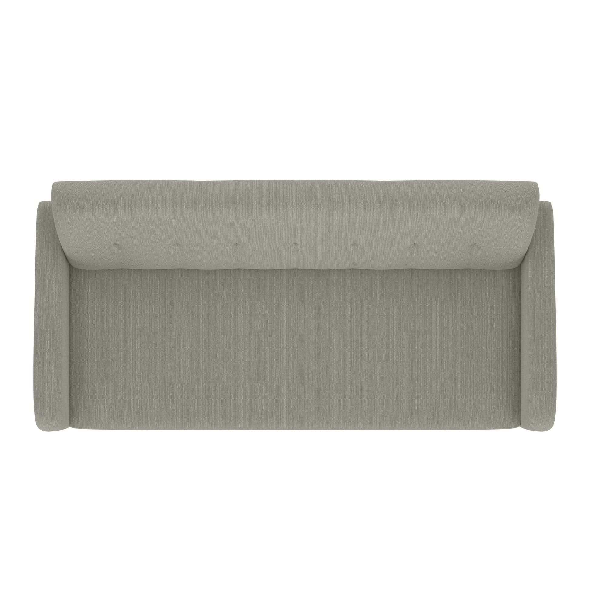Topdown view of a tufted light grey fabric armchair with clean lines