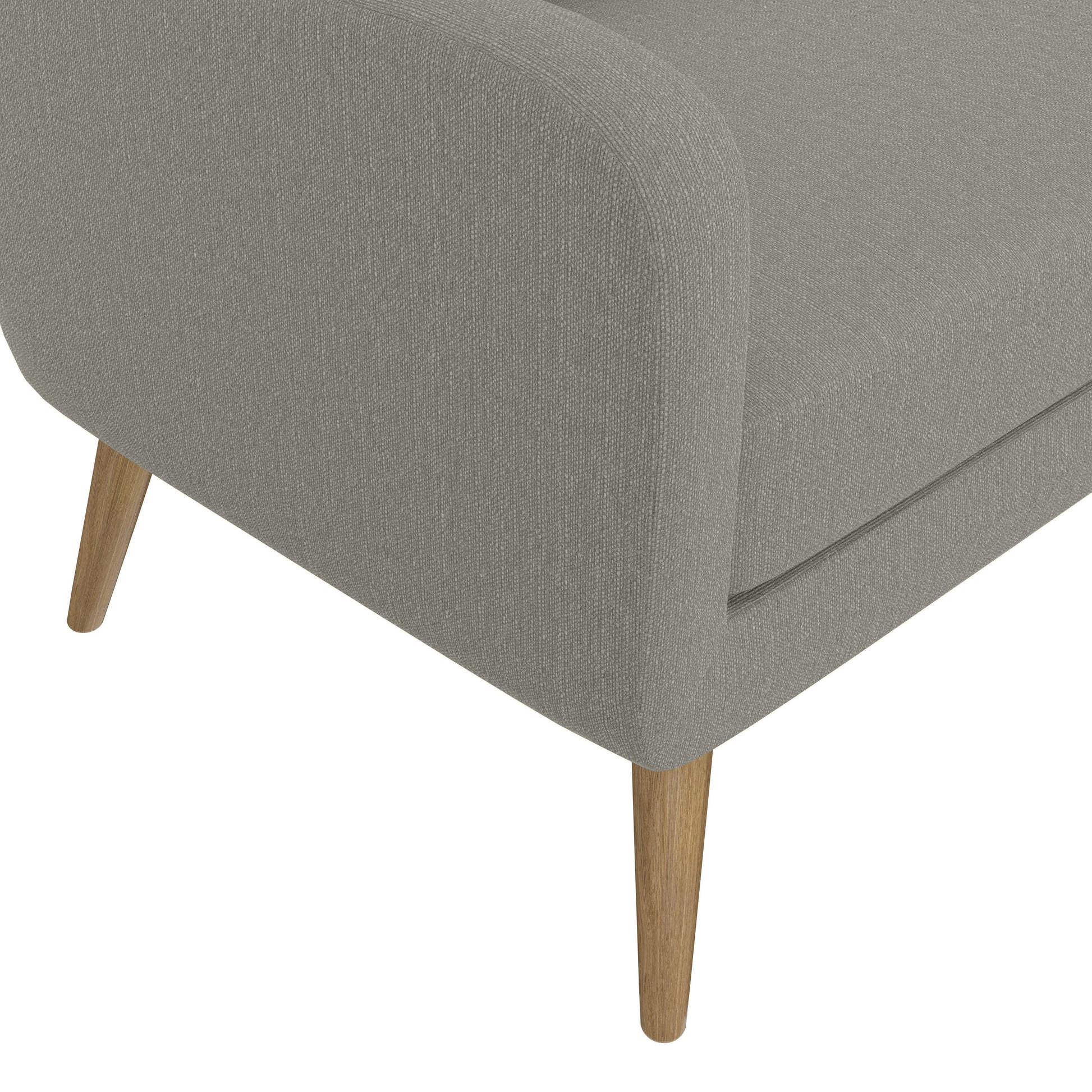 Closeup of a grey textured fabric armchair with tapered wooden legs
