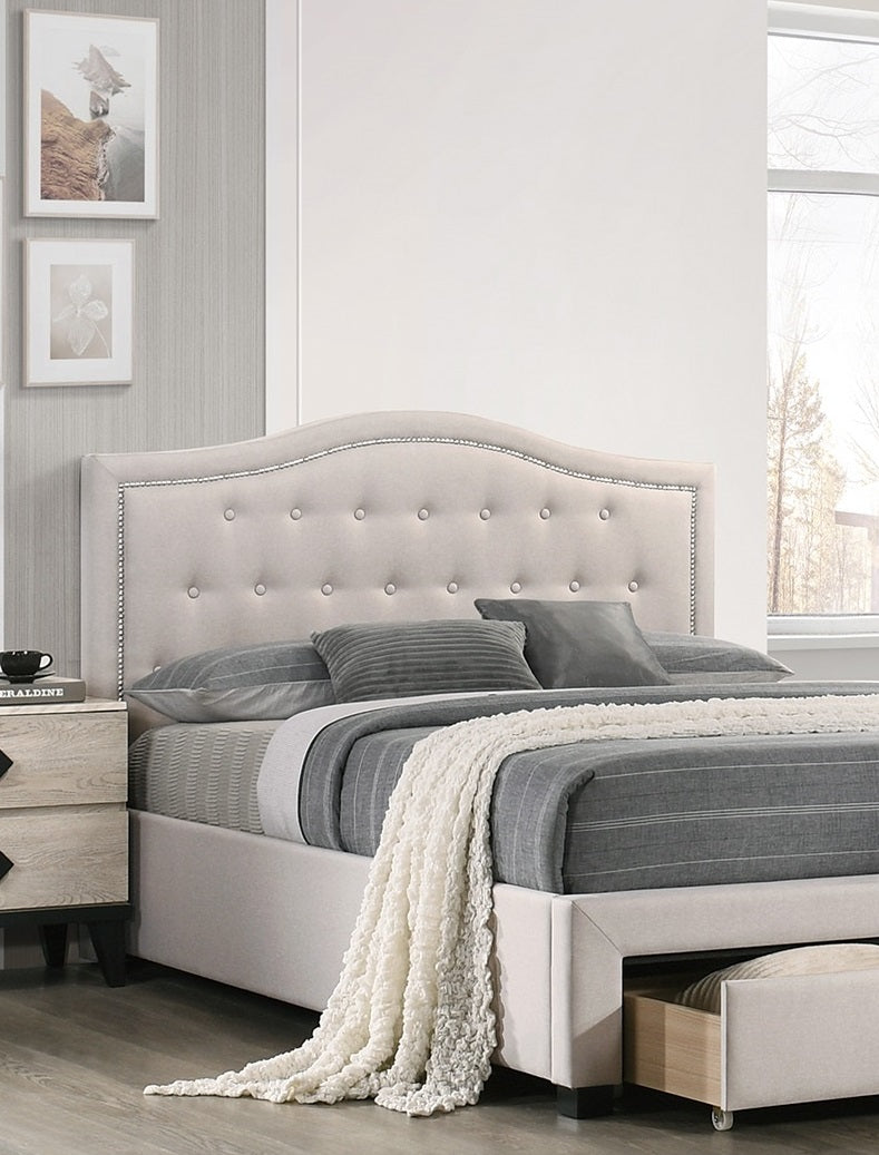 Upholstered beige bed with tufted headboard and silver nailhead trim perfect for a modern bedroom