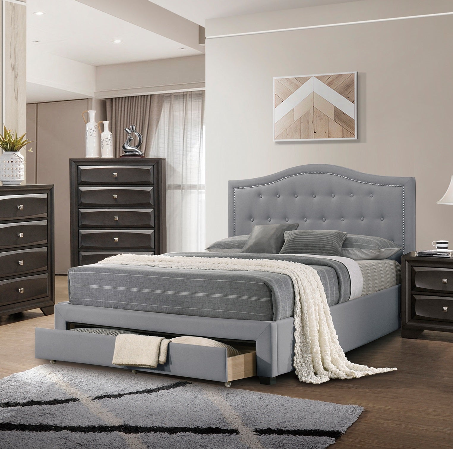 Grey upholstered bed frame with tufted headboard and trundle drawer
