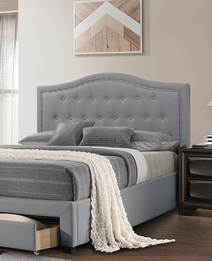 Gray upholstered bed with diamond tufting and nailhead trim headboard