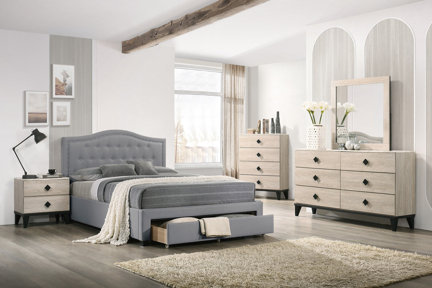 Gray tufted upholstered bed frame with storage drawer complementing wooden nightstand and dresser
