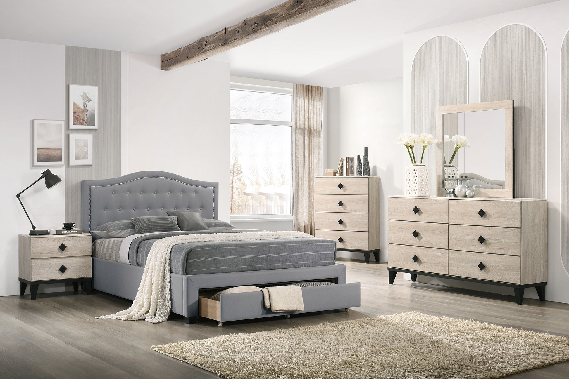 Gray tufted upholstered bed frame with storage drawer complementing wooden nightstand and dresser
