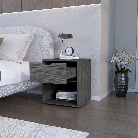 Grey wood nightstand with one open drawer and two shelves next to bed