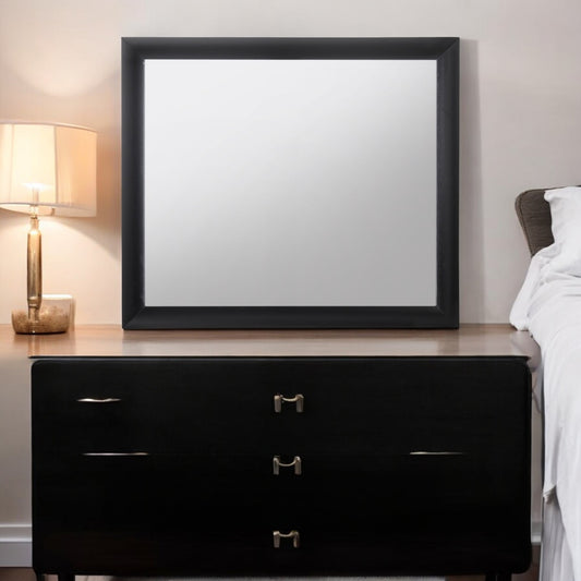 Black wood framed dresser mirror with three drawers