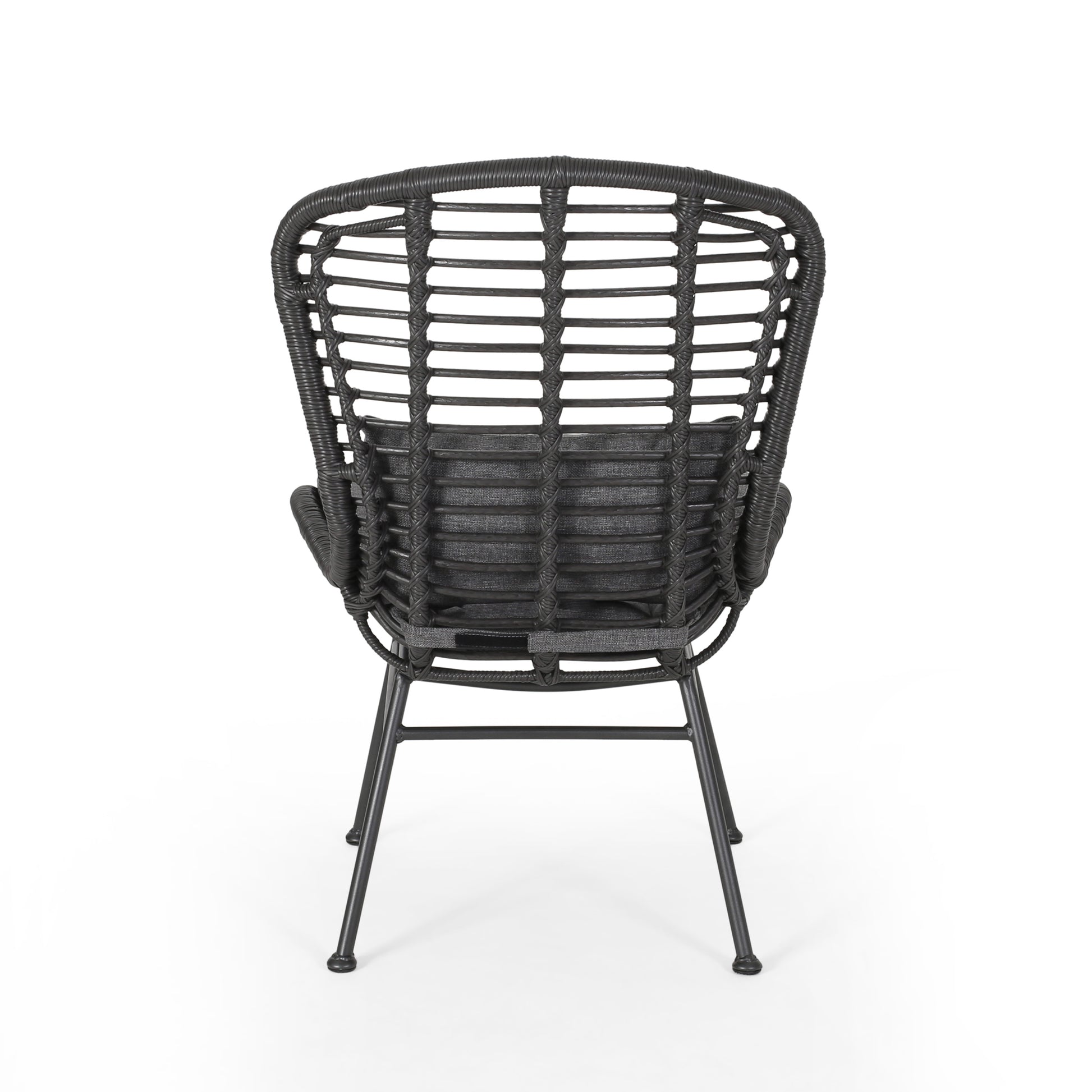 Dark grey rattan armchair with woven back and charcoal cushion
