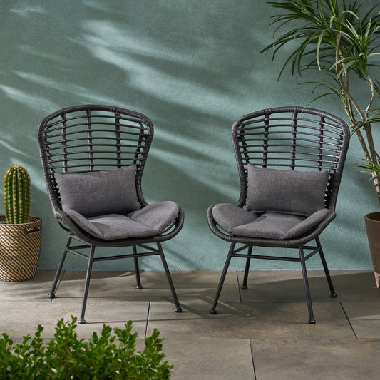 Two dark gray wicker patio chairs with charcoal cushions perfect for outdoor seating
