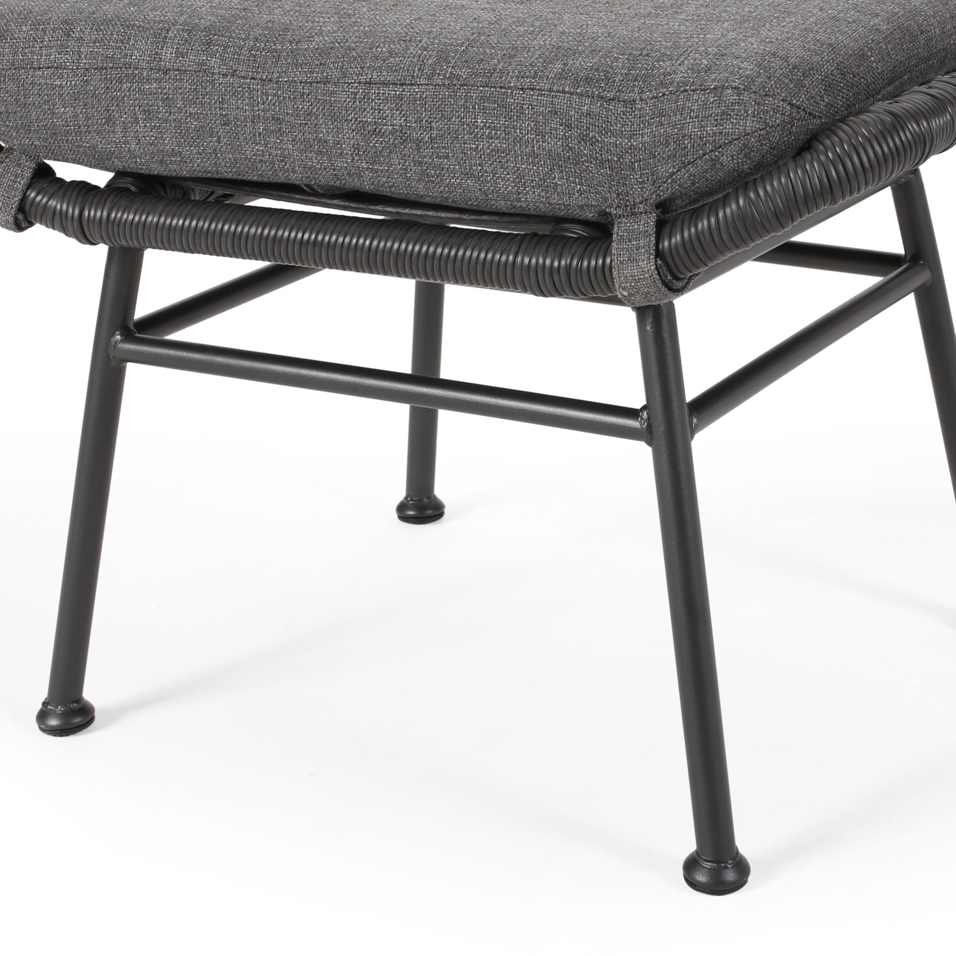 Dark grey upholstered ottoman with black woven rope detail and metal legs