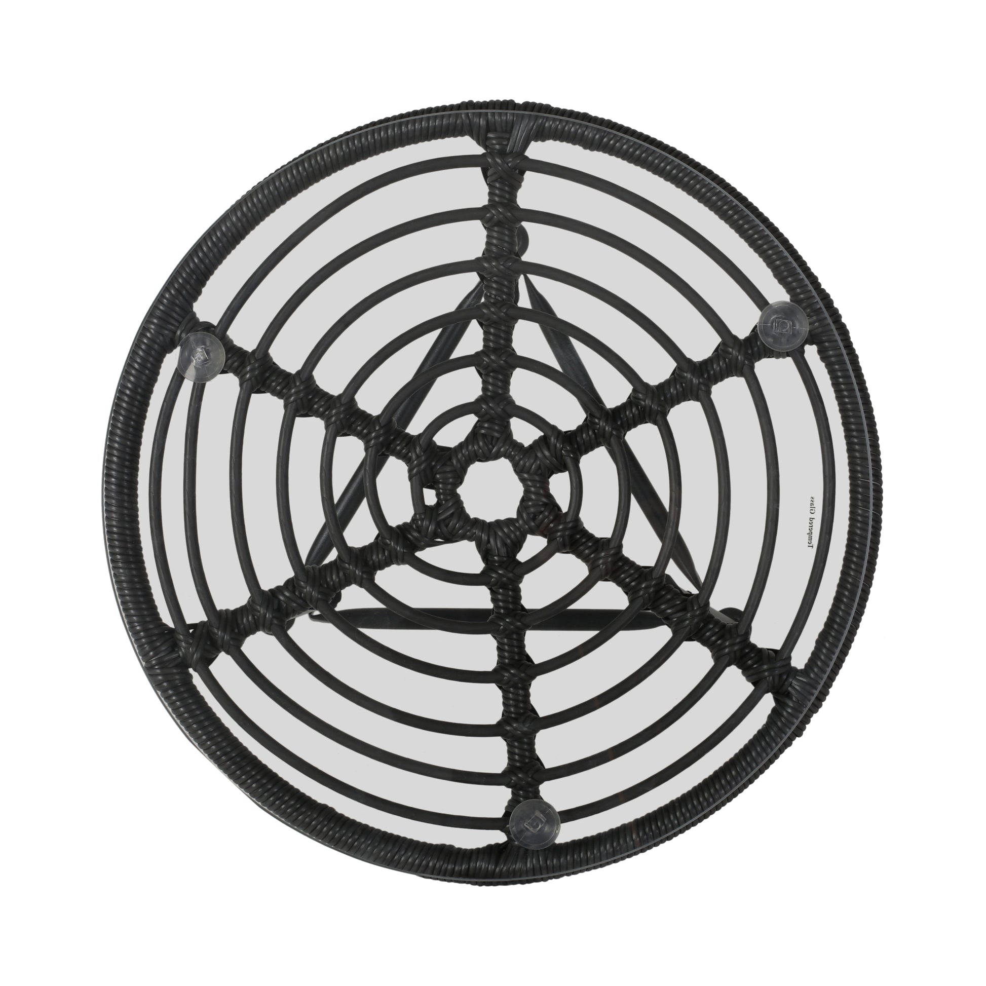 Round black rattan side table with clear glass top and intricate woven detail