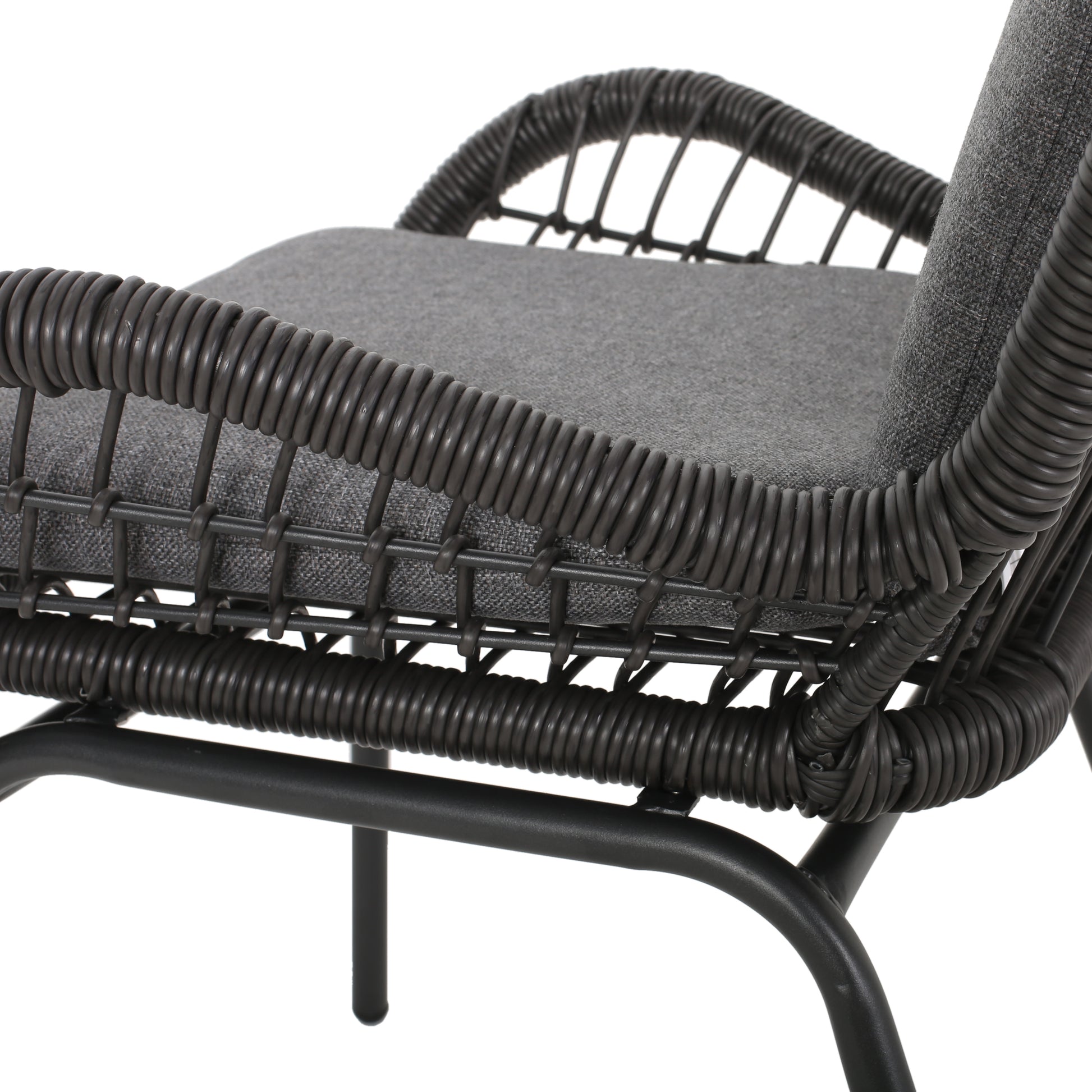 Woven rattan patio chair with a gray seat cushion and black metal legs