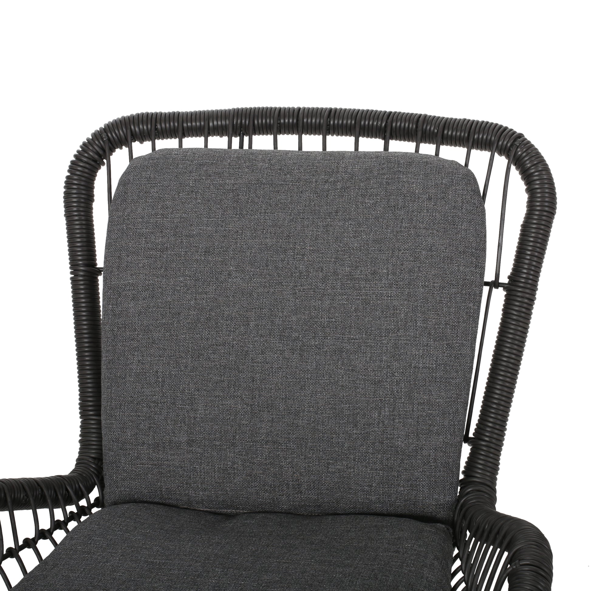Closeup of a charcoal grey wicker armchair cushion with textured fabric
