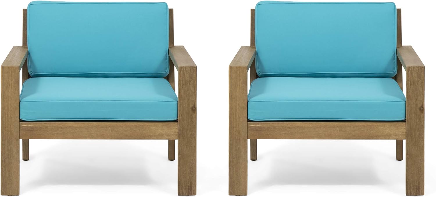 Two modern outdoor chairs with teal cushions and wooden frames