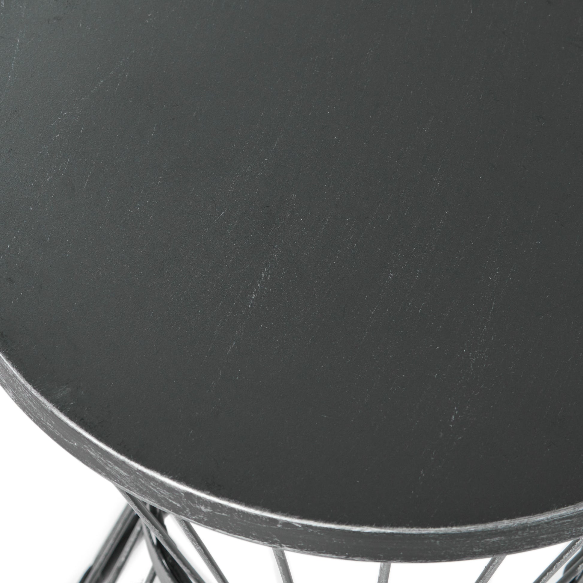 Dark gray round metal side table with distressed finish