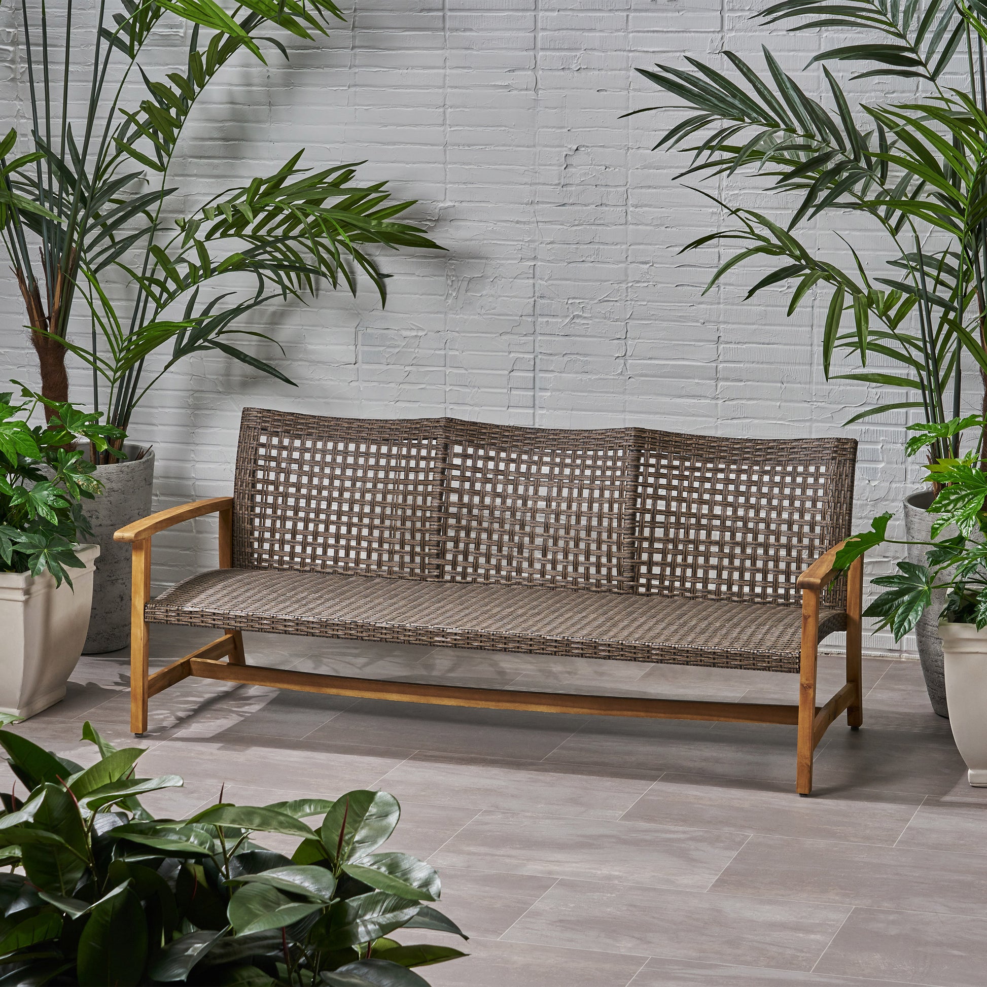 Brown wicker outdoor loveseat with wooden frame perfect for patios