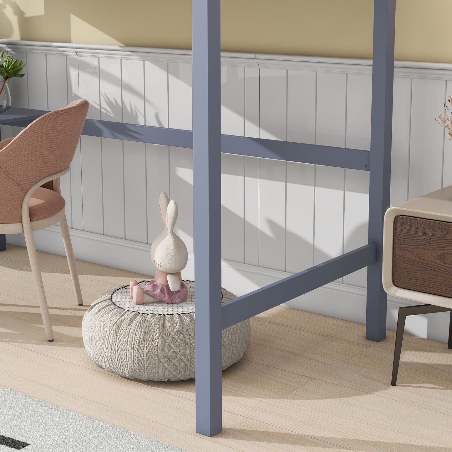 Grey metal loft bed frame with plush bunny toy on ottoman