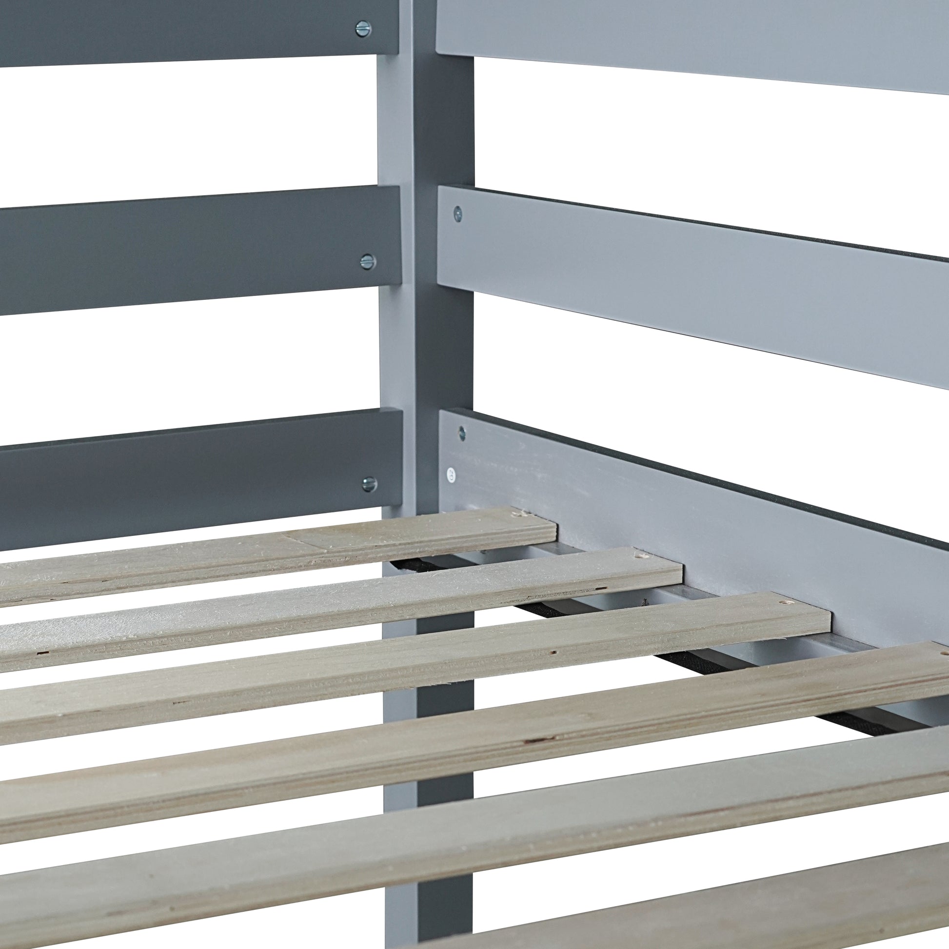 Closeup of grey metal bed frame with wooden slats for mattress support