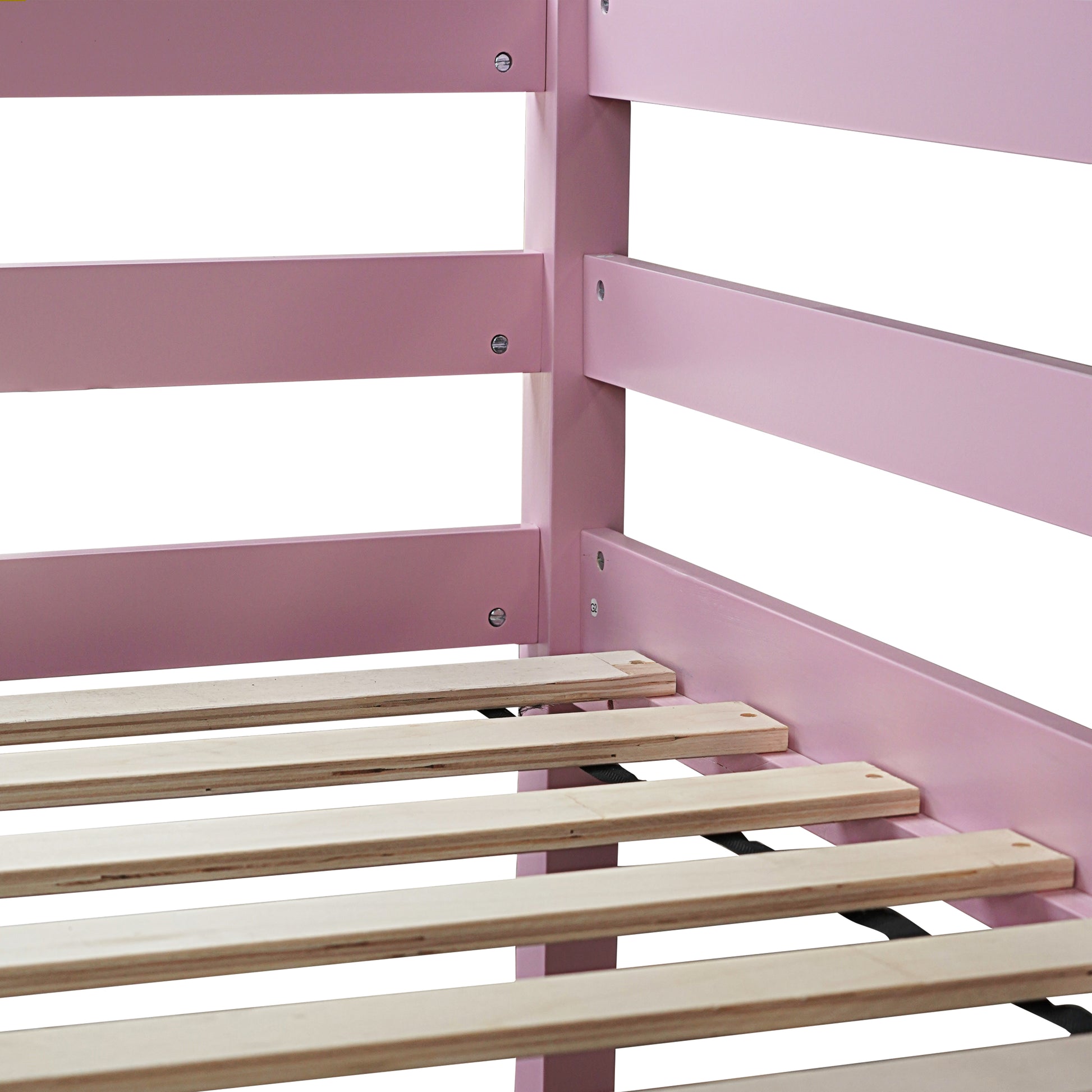 Closeup of a pink wooden bed frame with wooden slats