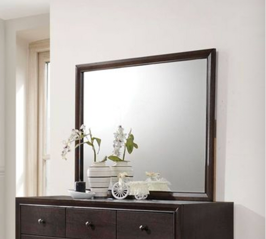 Dark wood dresser mirror with decorative vases and white miniature bicycle