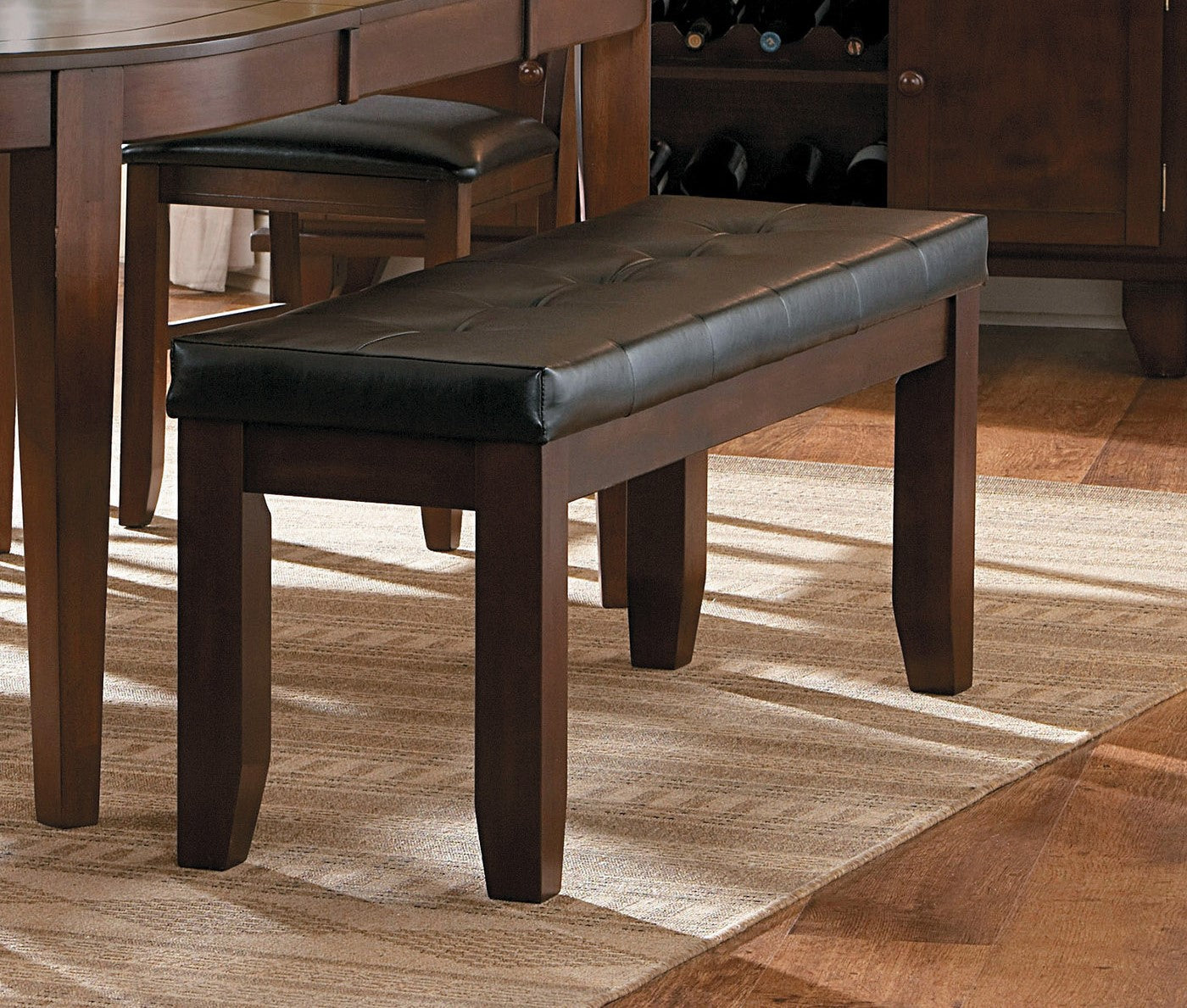 Tufted dark brown faux leather dining bench with dark wood legs