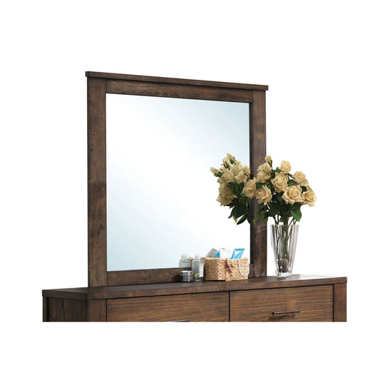 Dark wood dresser with attached mirror and vase of light roses