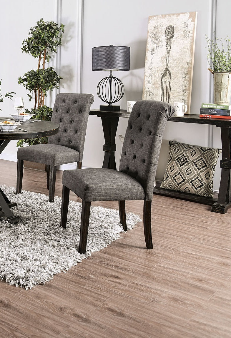 Tufted grey fabric dining chair with dark wood legs and button detailing