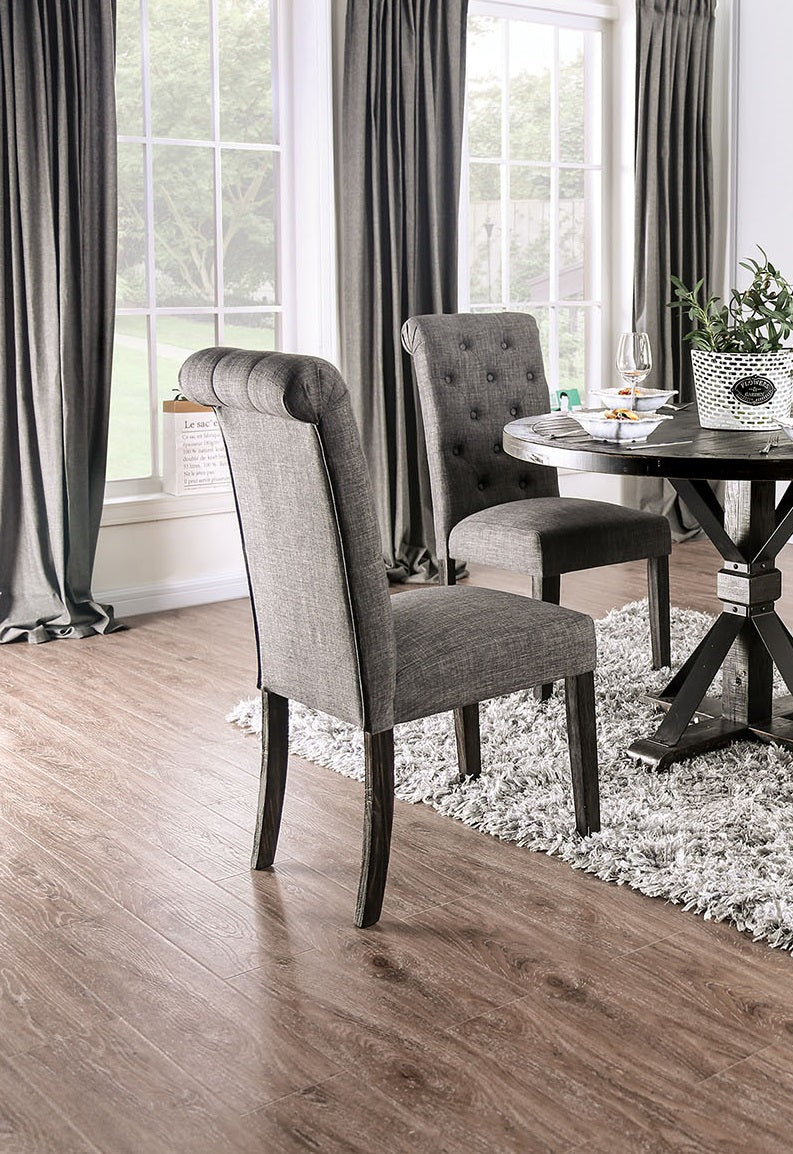 Gray upholstered dining chair with tufted back and dark wood legs