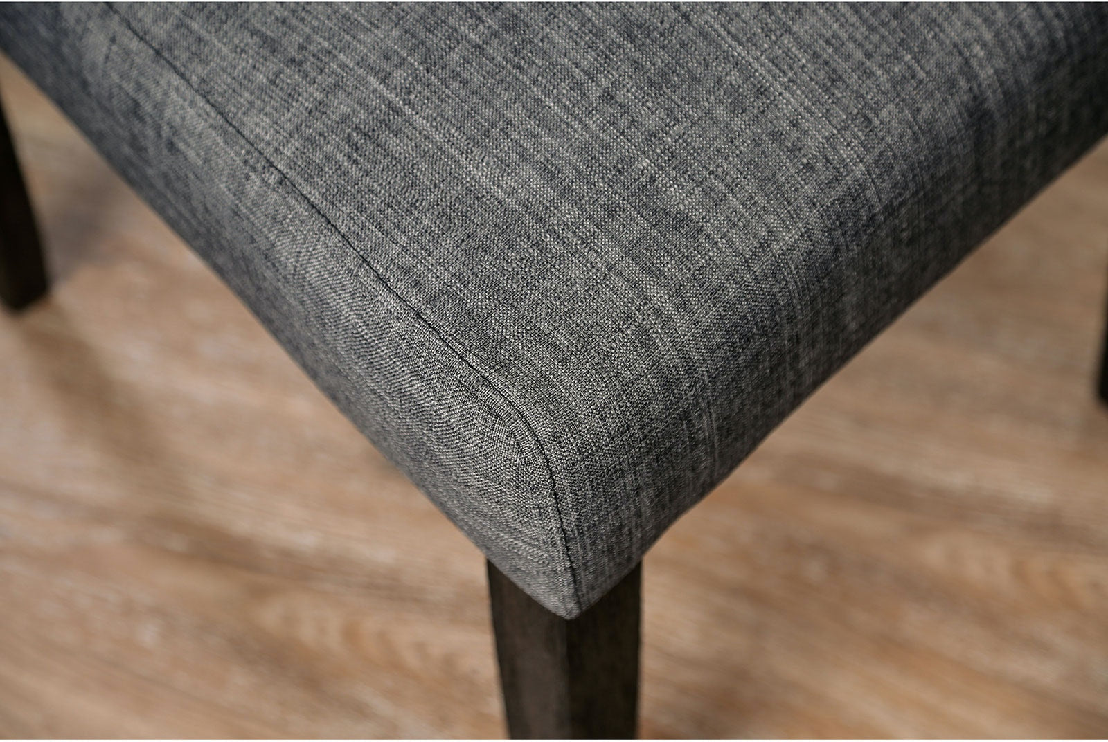 Closeup of gray textured fabric on a chair seat