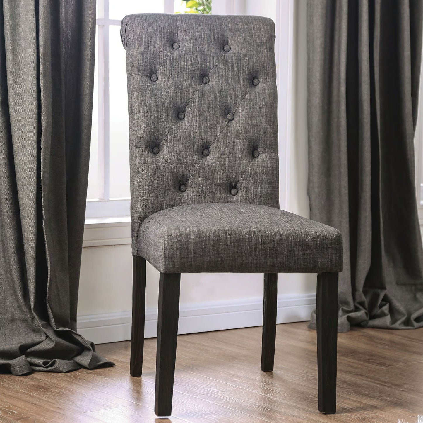Tufted grey upholstered dining chair with dark wood legs