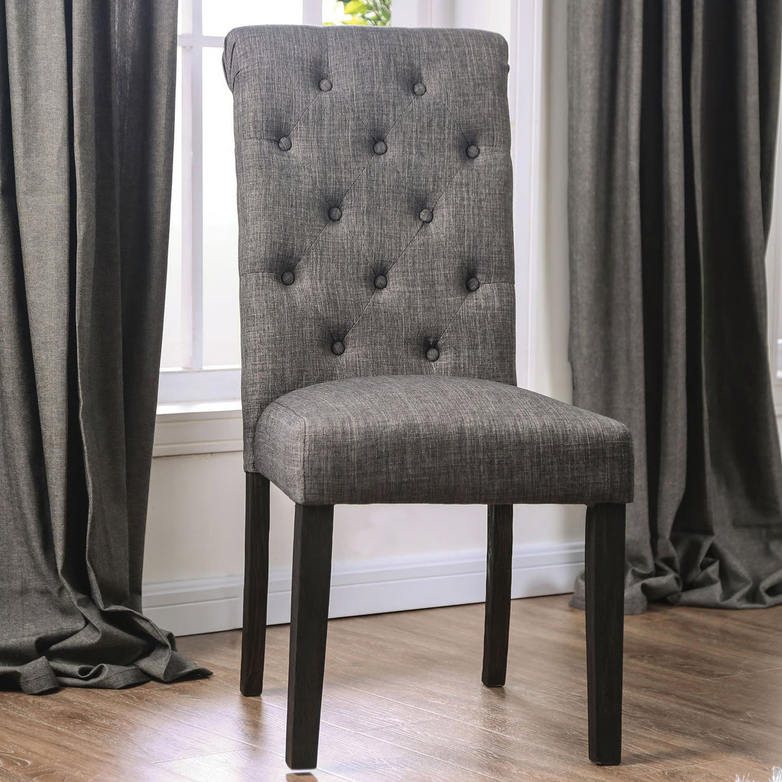 Tufted grey upholstered dining chair with dark wood legs