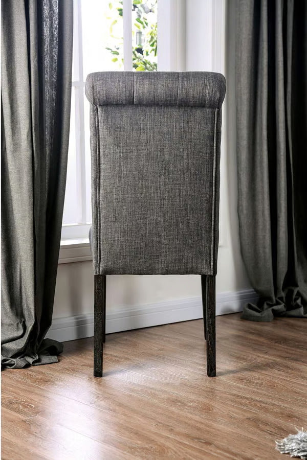 Grey upholstered dining chair with tufted back and dark wood legs